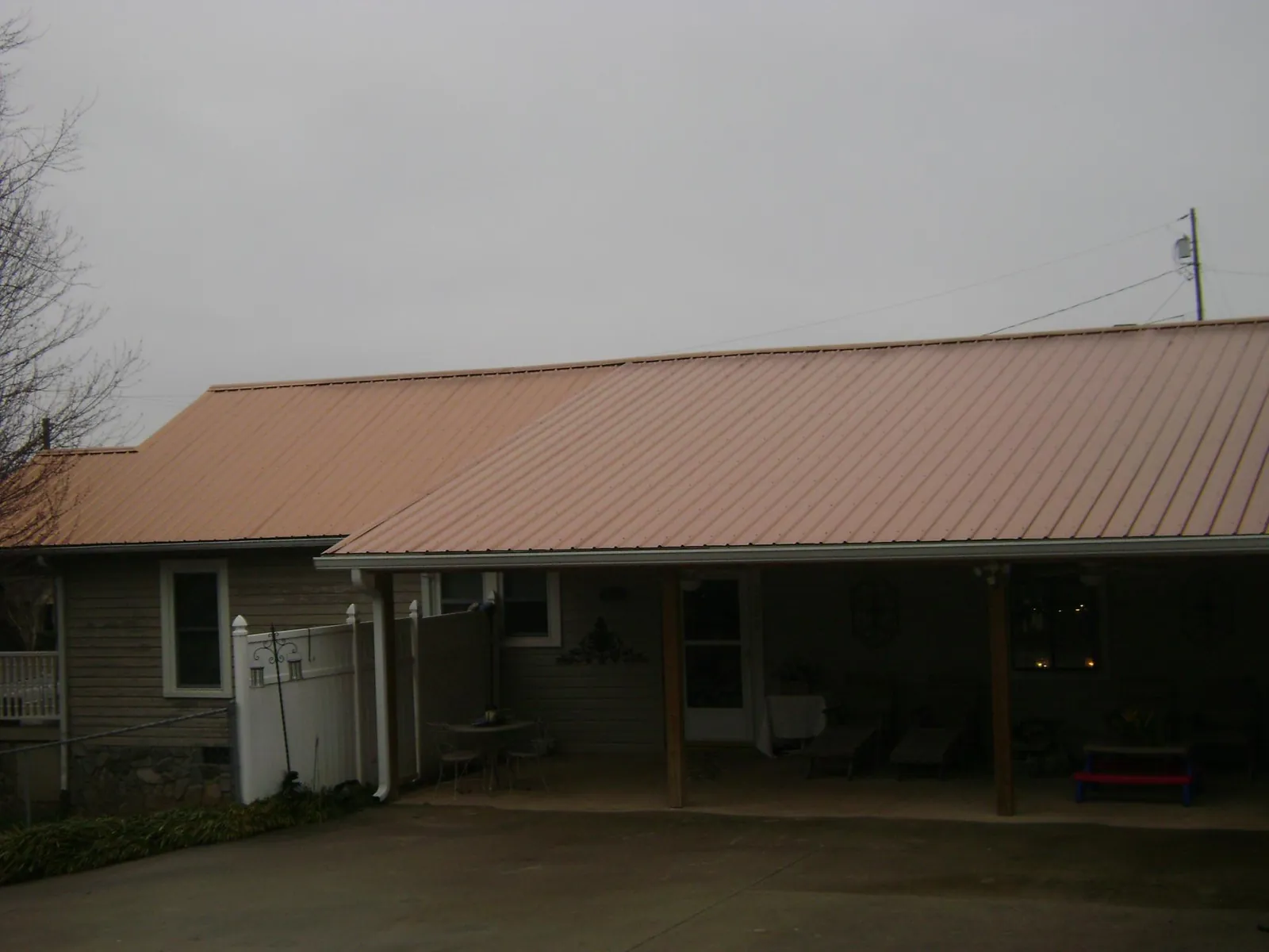 Copper toned metal roof over a wide covered patio in Burlington